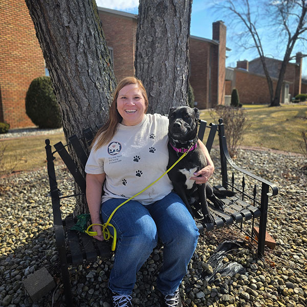 A professional dog walker on a park bench in Schererville, Indiana