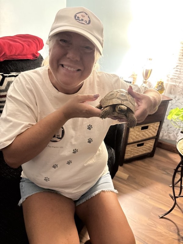 Pet Parlor sitter Marianne with Tort the turtle in St. John, Indiana